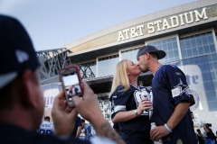 Caitlin Talbott, background left, and her boyfriend John Lee, right, both of Arlington, kiss and are photographed
during the Cowboys draft party at AT&T Stadium in Arlington, TX on April 30, 2015. (Kye R. Lee/The Dallas Morning News)